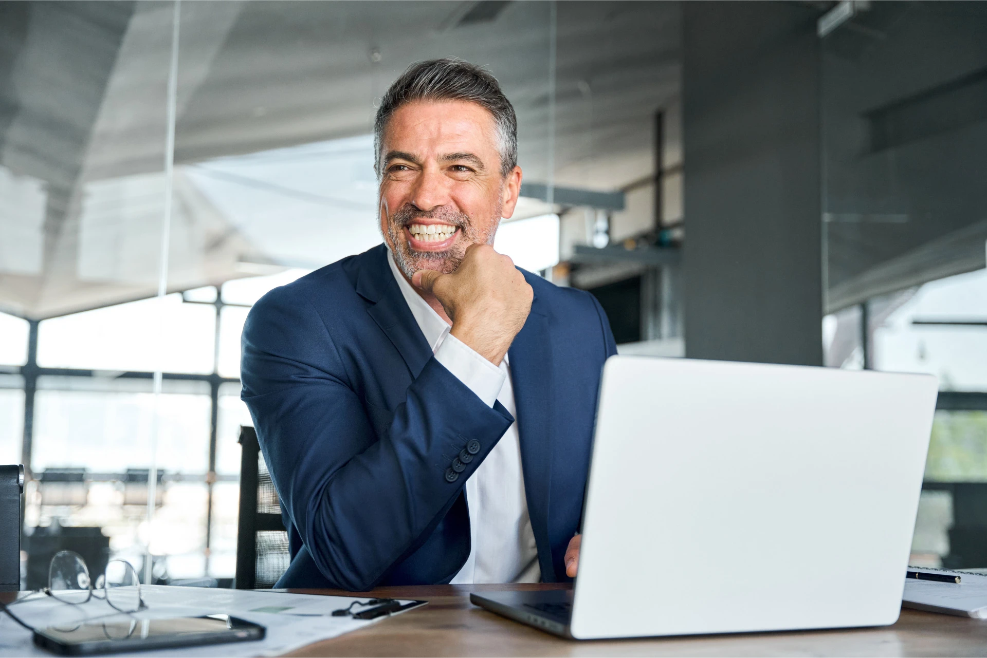 a smiling man with a laptop